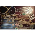 A VINTAGE COLLECTION INTERNATIONALLY DESIGNED GOLD PLATED AND GOLD TONE COSTUME JEWELRY SOLD AS IS