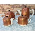 AN ANTIQUE COPPER COVERED PORCELAIN TEA SET MADE IN ENGLAND SOLD AS IS