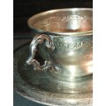 A VINTAGE SILVER PLATED TEA CUP AND SAUCER