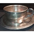 A VINTAGE SILVER PLATED TEA CUP AND SAUCER
