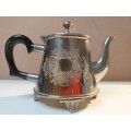 AN ORNATE VINTAGE TEAPOT WITH A BEAUTIFULL ENGRAVIVING SOLD AS IS