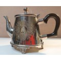 AN ORNATE VINTAGE TEAPOT WITH A BEAUTIFULL ENGRAVIVING SOLD AS IS