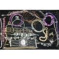 A BULK VINTAGE COLLECTION OF BRACELETS AND BANGLES SOLD AS IS
