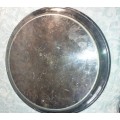 A ROUND CATERERS TRAY SILVER PLATED NEEDS TO BE POLISHED AND SOLD AS IS