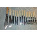 A COLLECTION OF BONE HANDLED CUTLERY SOLD AS IS