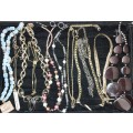 A VINTAGE COLLECTION OF GOLDPLATED AND BEADED COSTUME NECKLACES