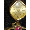 AN ANTIQUE SWISS-MADE ATLANTIC 17 JEWELS BROOCHE WATCH WITH A RUBY STONE