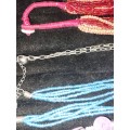 A COLLECTION OF DENSE MULTI STRAND NECKLACES SOLD AS IS