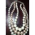 A COLLECTION OF HIGH QUALITY DESIGNER MULTI STRAND COSTUME NECKLACES SOLD AS IS