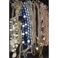 A BULK DESIGNER GOLD PLATED, GOLD TONE, AND HEAVY BEADED COSTUME NECKLACES