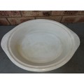 AN OVEN PROOF PORCELAIN CASSEROLE BOWL WITH A STAINLESS STEEL CANDLE STAND WARMER