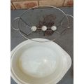 AN OVEN PROOF PORCELAIN CASSEROLE BOWL WITH A STAINLESS STEEL CANDLE STAND WARMER