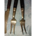 A SET OF FOUR BRASS AND WOOD KNIVES AND FORKS