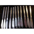 A COLLECTION OF 11 STAINLESS STEEL KNIVES