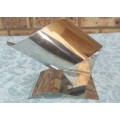 A SILVER PLATED WINE HOLDER CADDY SOLD AS IS