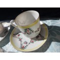 A COLLECTION OF HAND PAINTED TEA CUPS AND SAUCERS