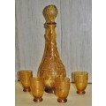 Vintage mid-century embossed amber glass decanter with four glasses