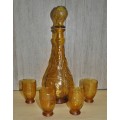 Vintage mid-century embossed amber glass decanter with four glasses