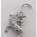 Vintage stamped silver tone metal lizard brooch with red rhinestone eyes