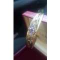 9ct yellow gold bangle with precious stones in box