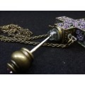 Beautiful vintage look cross with perfume bottle on long chain