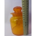Bright orange glass bottle and glass lid