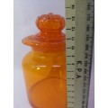 Small Bright orange glass bottle and glass lid