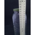 Old glass storage bottle with green tin lid