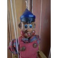 Wooden Pinocchio puppet on strings
