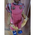 Wooden Pinocchio puppet on strings