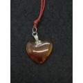 Semi-precious stone heart pendant on a string