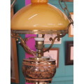 Vintage hanging lamp with orange shade.