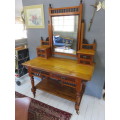 Early 20th century blonde mahogany two tier dressing table with a swing mirror.