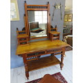 Early 20th century blonde mahogany two tier dressing table with a swing mirror.