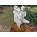 Decorative art piece - Three moulded ceramic nude figures on oxidised steel base