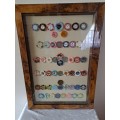 A Framed Collection of 53 World Cassino Chips Frame47cm x 68cm x3cm.