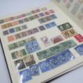 Slip in stamp album with almost 600 world stamps - Unresearched