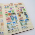 Stamp album with about 700 stamps - Some nice ones - In good condition