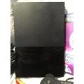 Playstation 2 - Black Slim Line Console c/w 1 x Generic Controller, AV Cable Power Cord & 1 x Game