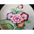 Display plate, Flowers , No Name 10cm in Diameter. Holes punched in back of plate