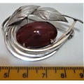 A Really Nice Silver Coloured  Brooch set with an Amber Coloured Stone