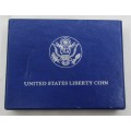 1986 United States of America Uncirculated Silver Dollar (900) encapsulated in box of issue with COA
