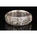Silver Bangle with moulded relief depicting flowers,
