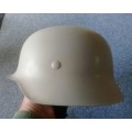 Classic German `steel` helmet - lightweight made from fibreglass with chinstrap. Size about 59cm.