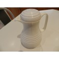 White cold/hot water jug with handle and insulated glass lined interior.