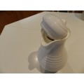 White cold/hot water jug with handle and insulated glass lined interior.