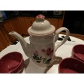 Tea/coffee Pot with 4x cups. Floral design in green and mauve with mauve cups with handle.