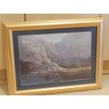 Picture Frame: Gilt frame with Mountain scene print in blue behind glass.