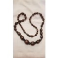 Vintage Costume Jewellery:  Necklace strung with brown plastic beads. Little girls dress-up type