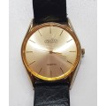 Vintage Mens watch / Astro Quartz.  c1970s.  Gold plated, round face with black leather strap.